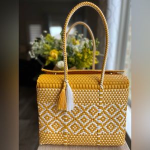 Beautifully hand handmade. Bucket tote with two snap buttons for privacy.